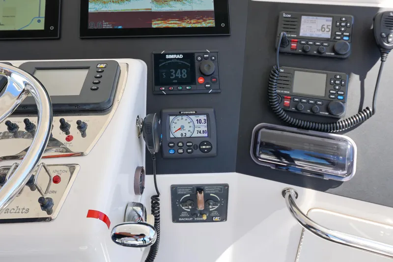 Legacy Yacht Photos Pics Control panel of a 2004 Cabo 40 Flybridge Convertible with navigation and communication equipment.