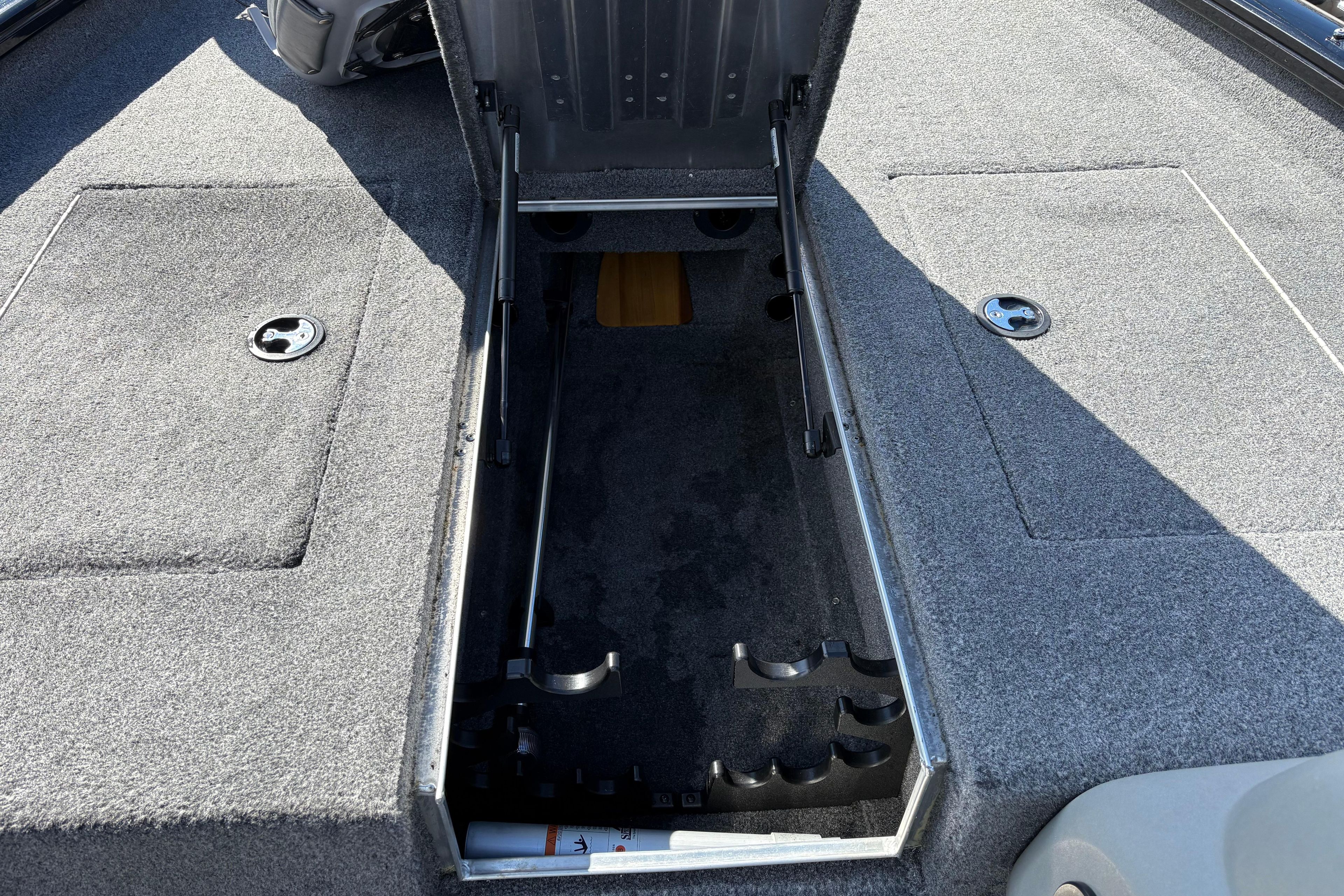 2017 Tracker Pro Team 175 TXW boat with open storage compartment.