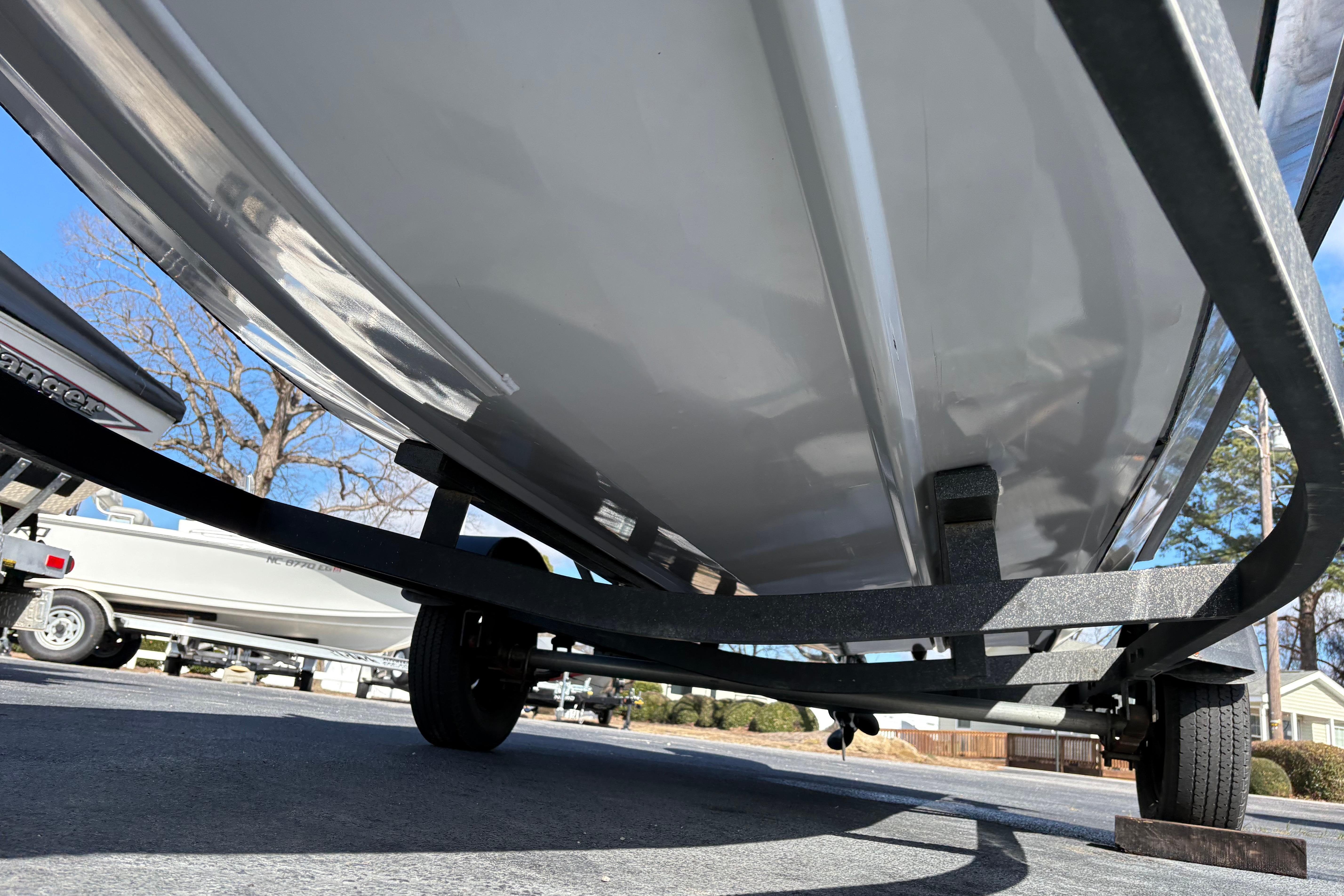 2017 Tracker Pro Team 175 TXW boat on trailer, underside view, parked outdoors.