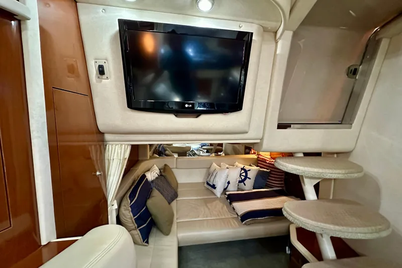 Lonie Marie Yacht Photos Pics Interior of 2008 Sea Ray 340 Sundancer with TV, cozy seating, and nautical decor.