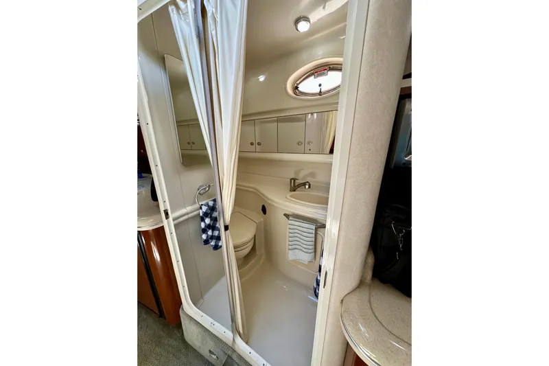 Lonie Marie Yacht Photos Pics 2008 Sea Ray 340 Sundancer bathroom with shower, sink, and storage cabinets.