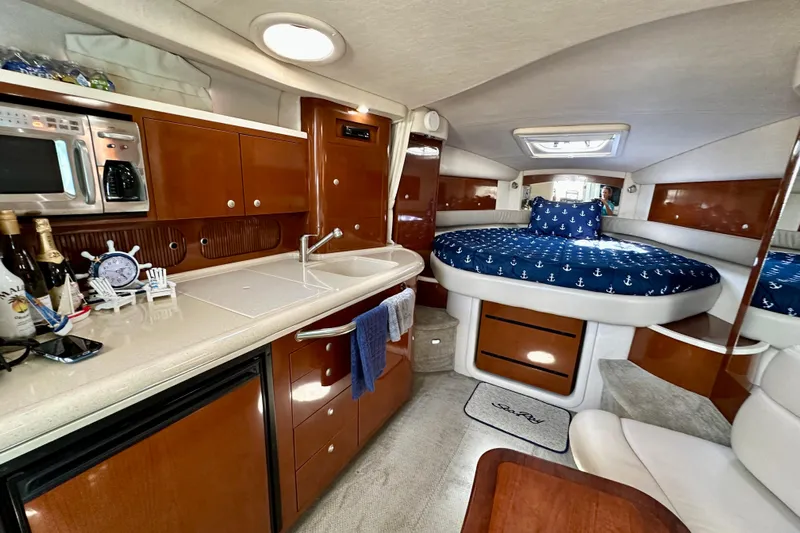 Lonie Marie Yacht Photos Pics Luxurious interior of 2008 Sea Ray 340 Sundancer with kitchenette and cozy sleeping area.
