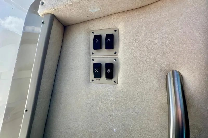 Lonie Marie Yacht Photos Pics Control panel on 2008 Sea Ray 340 Sundancer boat interior with switches and handle.