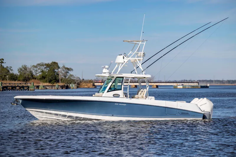  Yacht Photos Pics 2019 Boston Whaler 350 Outrage boat on calm water, clear sky background.