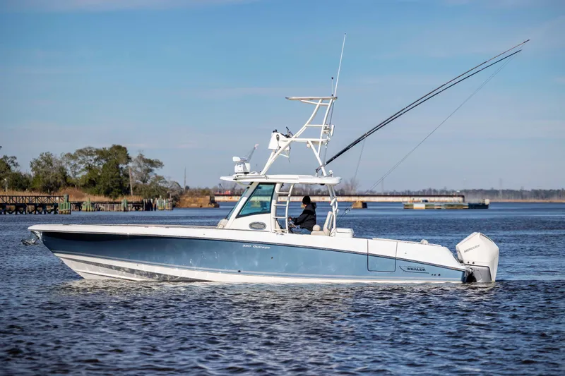 Yacht Photos Pics 2019 Boston Whaler 350 Outrage boat cruising on a calm river.