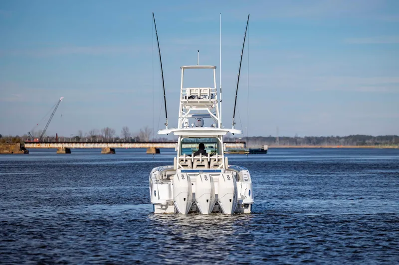  Yacht Photos Pics 2019 Boston Whaler 350 Outrage boat on calm water with bridge in background.