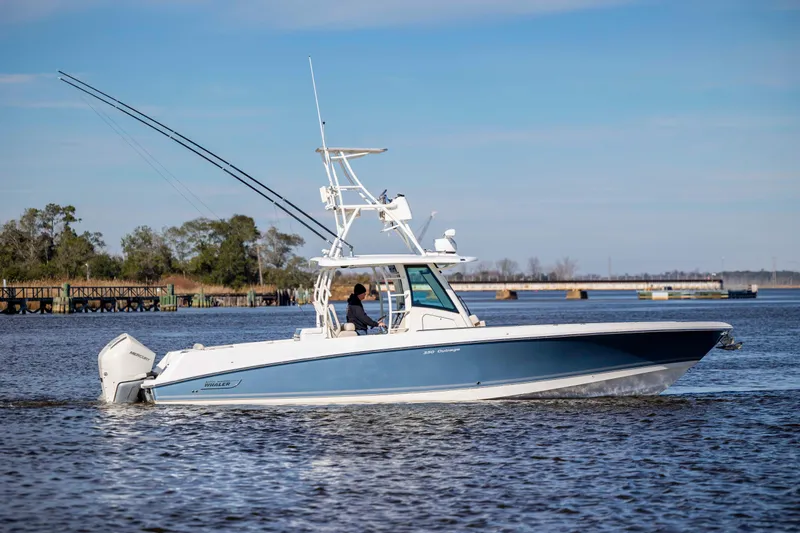  Yacht Photos Pics 2019 Boston Whaler 350 Outrage cruising on a calm river under a clear sky.