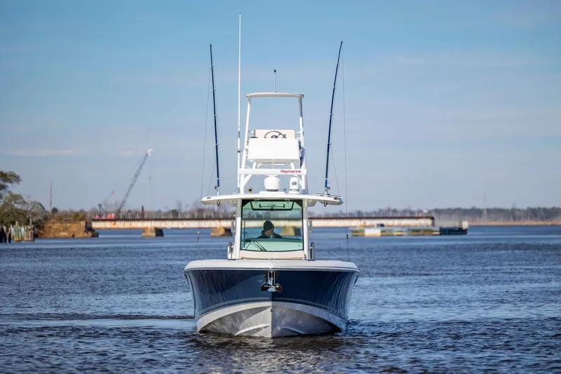  Yacht Photos Pics 2019 Boston Whaler 350 Outrage boat on calm water, clear sky background.