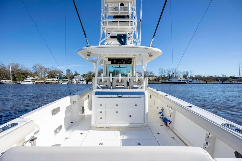  Yacht Photos Pics 2019 Boston Whaler 350 Outrage boat on calm water, showcasing spacious deck and seating.