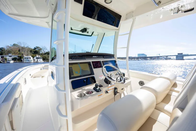  Yacht Photos Pics 2019 Boston Whaler 350 Outrage boat interior with modern navigation system and steering wheel.