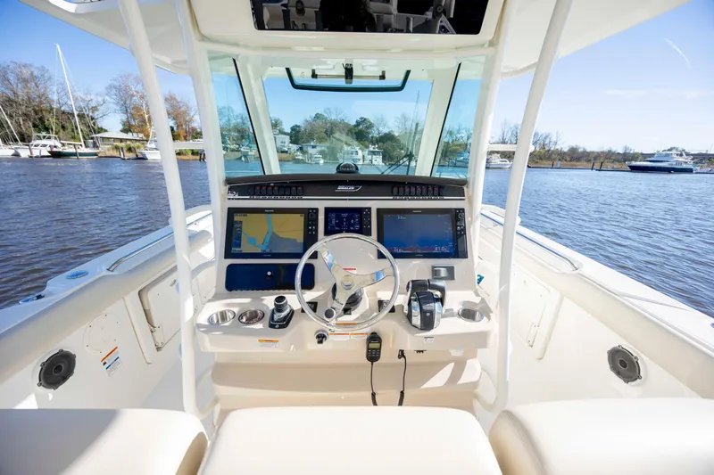  Yacht Photos Pics 2019 Boston Whaler 350 Outrage helm with advanced navigation systems on a sunny day.
