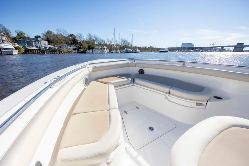  Yacht Photos Pics 2019 Boston Whaler 350 Outrage boat interior with cushioned seating on a sunny day.