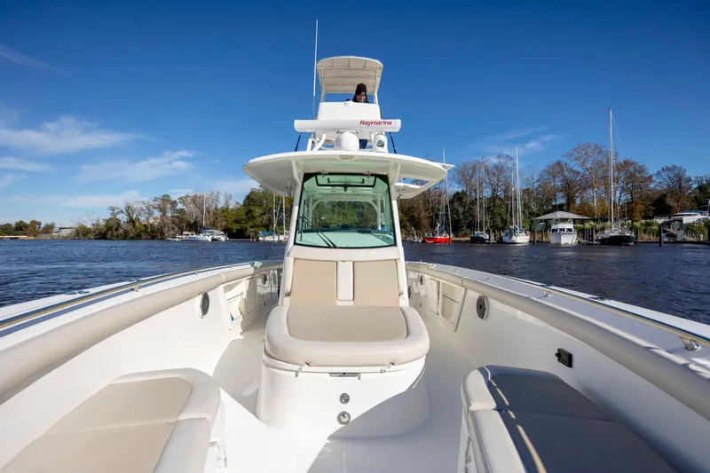 Yacht Photos Pics 2019 Boston Whaler 350 Outrage boat on calm water, clear sky, and scenic background.