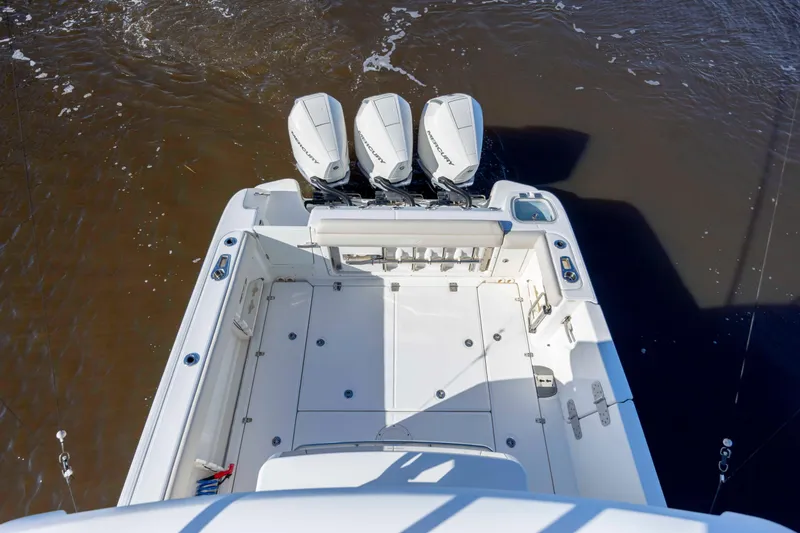  Yacht Photos Pics 2019 Boston Whaler 350 Outrage boat with triple outboard engines on water.