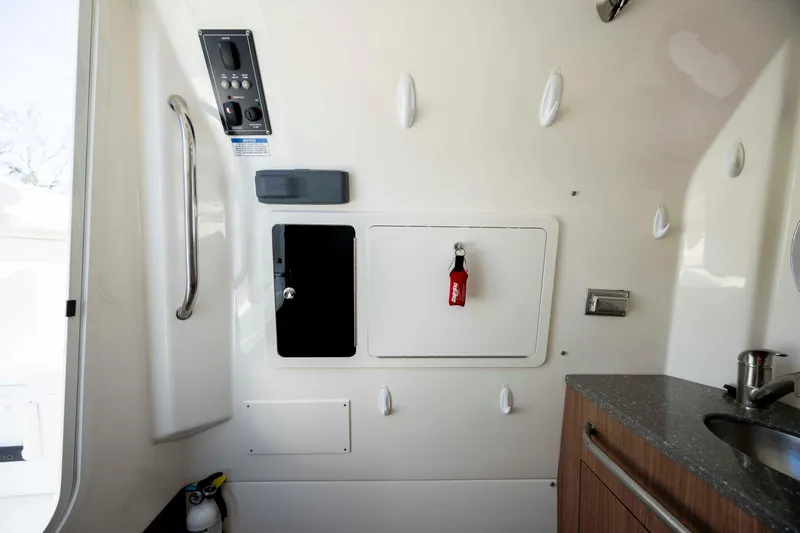  Yacht Photos Pics Interior of 2019 Boston Whaler 350 Outrage boat, featuring control panel and storage.