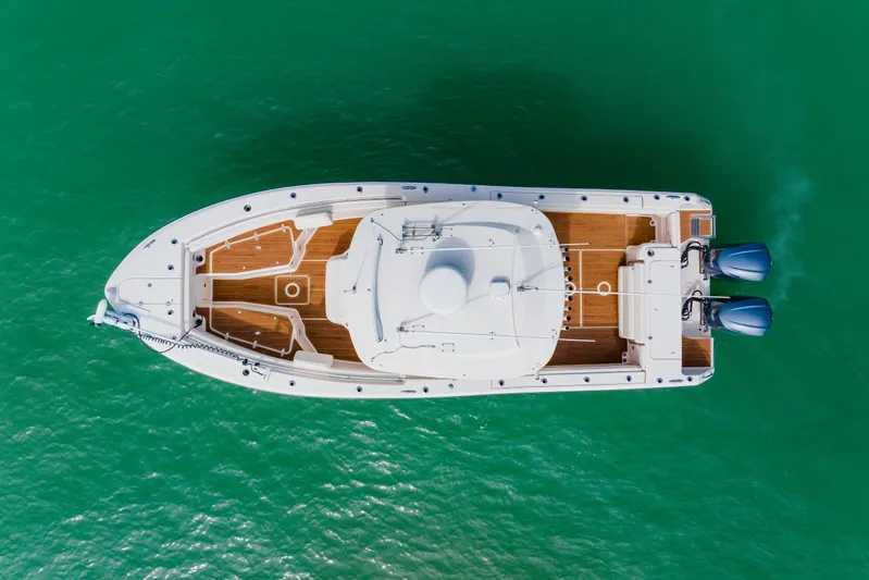  Yacht Photos Pics Aerial view of 2021 Grady-White Canyon 306 boat on turquoise water.