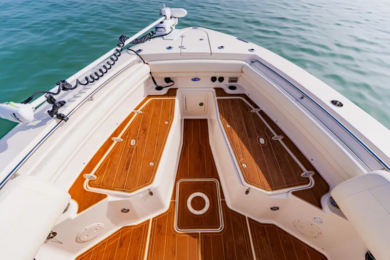  Yacht Photos Pics 2021 Grady-White Canyon 306 boat deck with teak flooring on calm water.