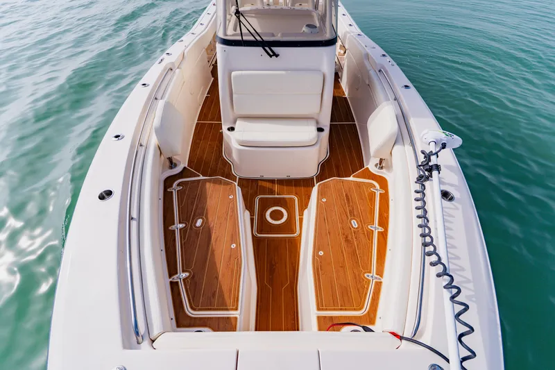  Yacht Photos Pics 2021 Grady-White Canyon 306 boat with teak deck, on calm water.