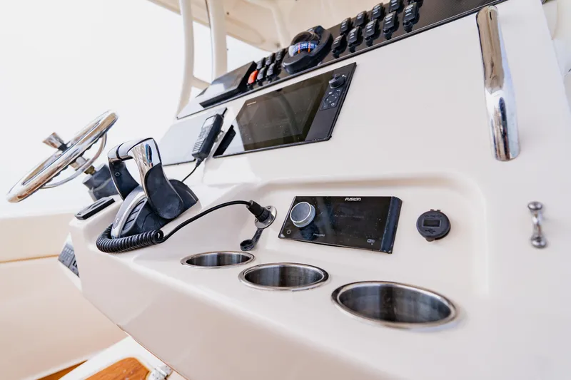  Yacht Photos Pics Control panel of 2021 Grady-White Canyon 306 boat with steering wheel and electronics.