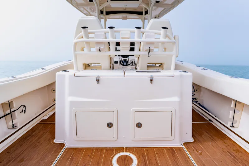  Yacht Photos Pics 2021 Grady-White Canyon 306 boat interior with teak flooring and fishing rod holders.