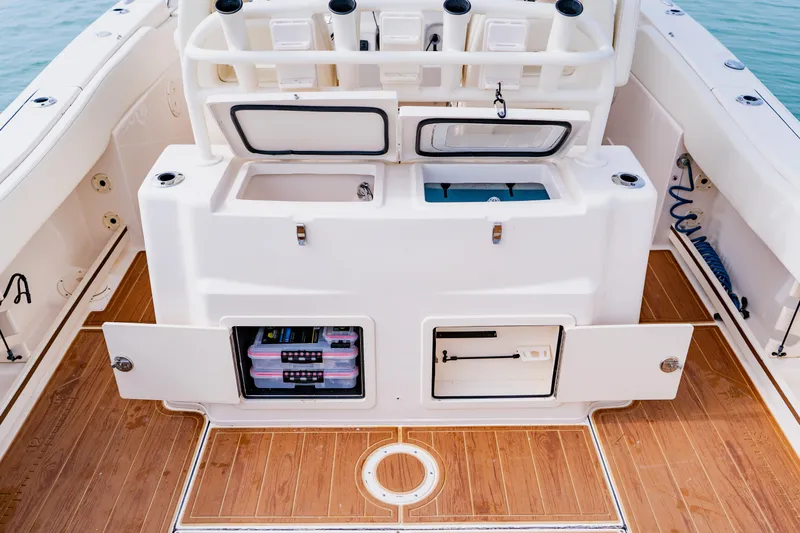  Yacht Photos Pics 2021 Grady-White Canyon 306 boat interior with storage compartments and wooden deck.