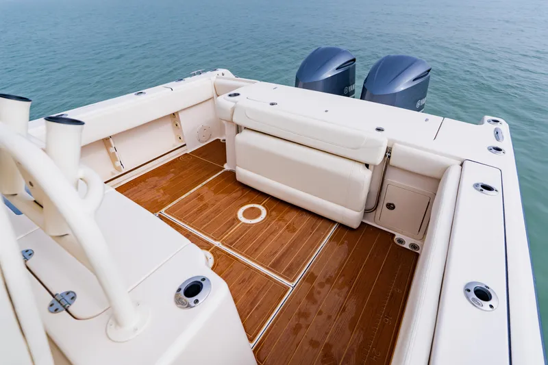  Yacht Photos Pics 2021 Grady-White Canyon 306 boat deck with seating and twin engines on water.