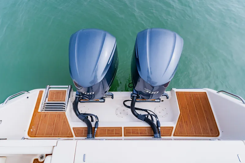  Yacht Photos Pics 2021 Grady-White Canyon 306 boat with twin outboard engines on water.