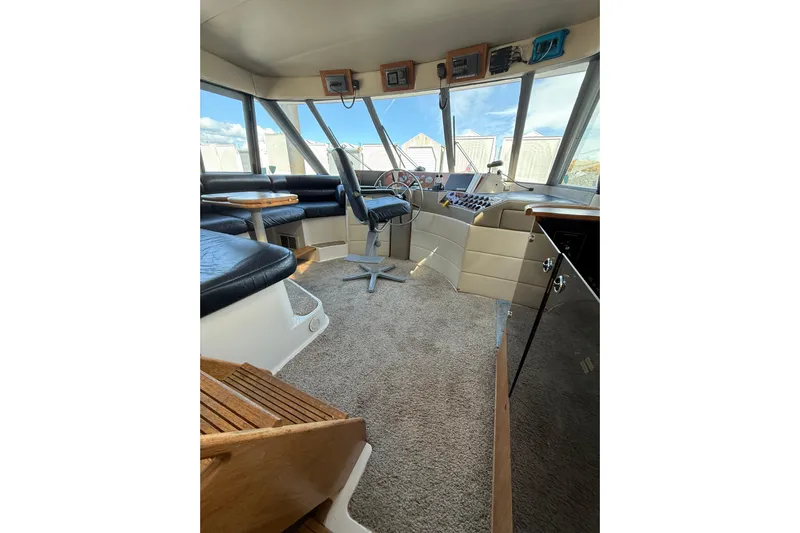 At Ease Yacht Photos Pics Interior of 1997 Bayliner 47 Motoryacht with helm, seating, and panoramic windows.