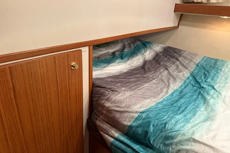 At Ease Yacht Photos Pics Cozy cabin interior of 1997 Bayliner 47 Motoryacht with colorful bedding.