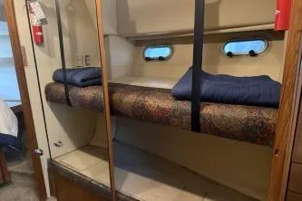At Ease Yacht Photos Pics 1997 Bayliner 47 Motoryacht interior with bunk beds and porthole windows.