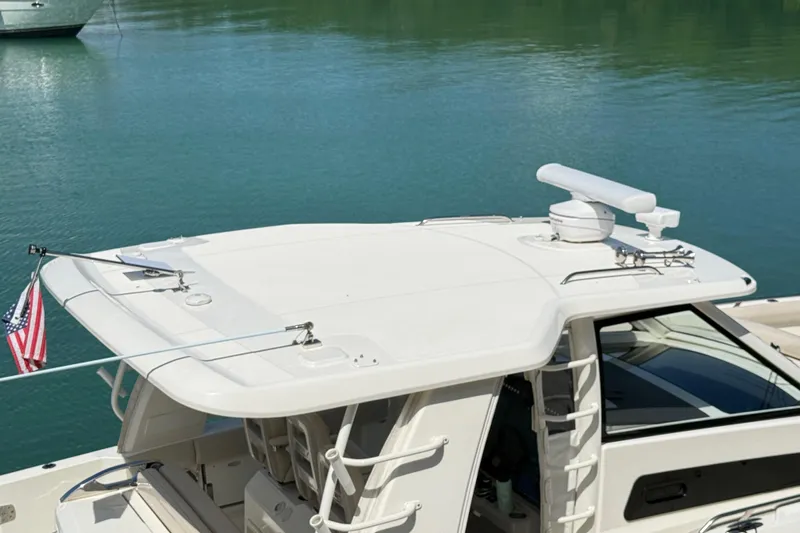  Yacht Photos Pics 2017 Boston Whaler 420 Outrage boat on calm water, featuring radar and American flag.