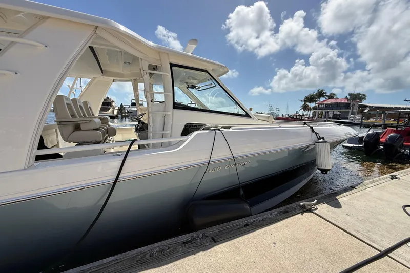  Yacht Photos Pics 2017 Boston Whaler 420 Outrage docked under a sunny sky.
