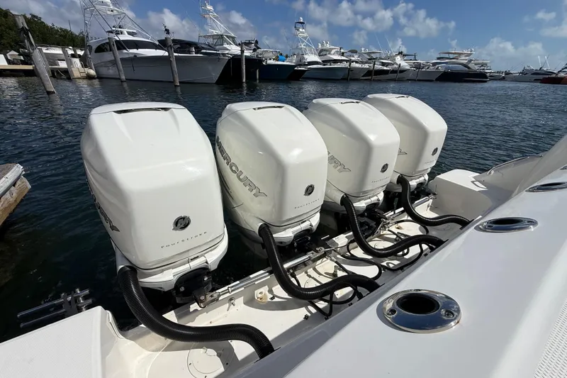  Yacht Photos Pics 2017 Boston Whaler 420 Outrage with four Mercury outboard engines docked at marina.