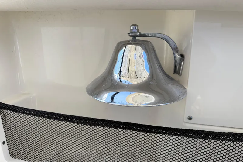  Yacht Photos Pics Chrome bell on 2017 Boston Whaler 420 Outrage boat, mounted on white surface.