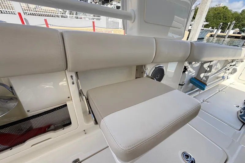  Yacht Photos Pics 2017 Boston Whaler 420 Outrage boat interior with beige seating and storage compartments.