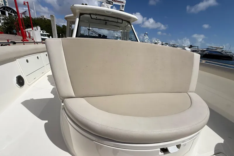  Yacht Photos Pics 2017 Boston Whaler 420 Outrage boat with beige seating, docked under a clear blue sky.