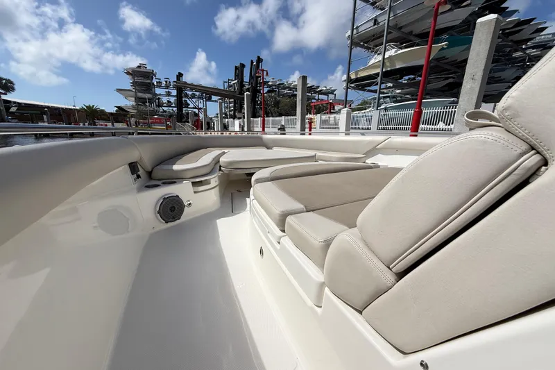  Yacht Photos Pics 2017 Boston Whaler 420 Outrage interior with cushioned seating and speaker, docked under blue sky.