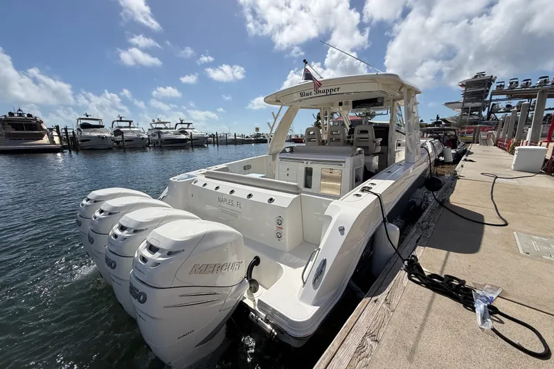  Yacht Photos Pics 2017 Boston Whaler 420 Outrage docked, featuring triple Mercury engines, under a sunny sky.