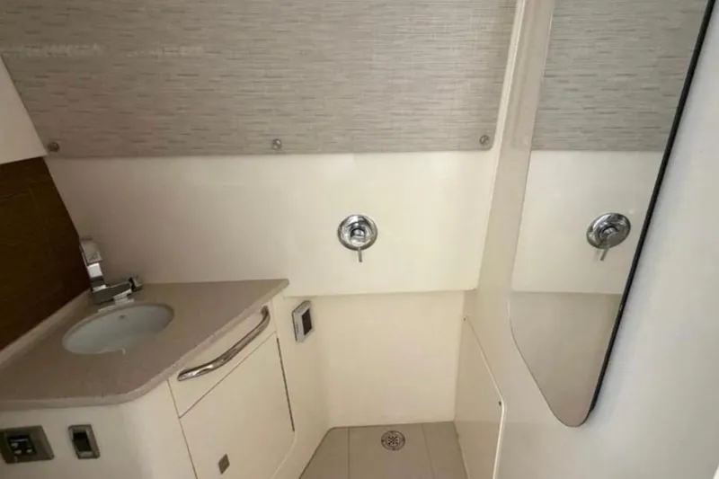  Yacht Photos Pics 2017 Boston Whaler 420 Outrage bathroom with sink, mirror, and modern fixtures.