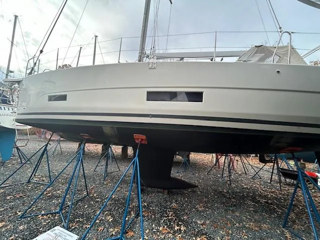 Sirene Yacht Photos Pics 2019 Dufour 390 GL sailboat on stands, viewed from the side, in a boatyard.