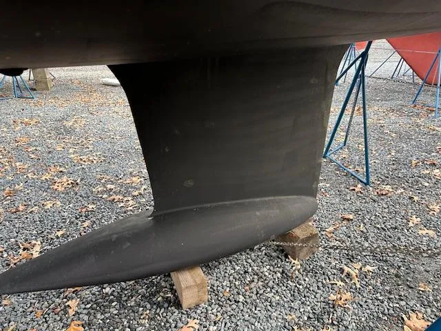 Sirene Yacht Photos Pics Keel of 2019 Dufour 390 GL sailboat on gravel with support stands.