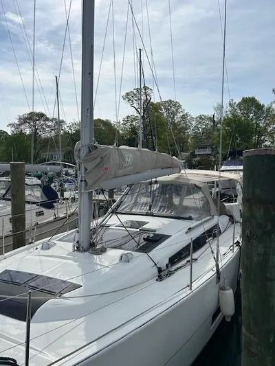 Sirene Yacht Photos Pics 2019 Dufour 390 GL sailboat docked at marina, surrounded by trees and other boats.