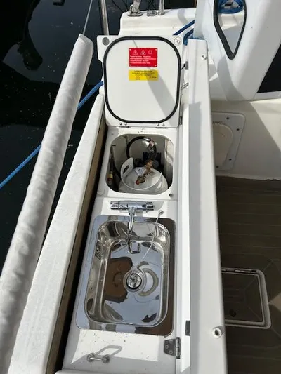 Sirene Yacht Photos Pics Dufour 390 GL 2019 yacht deck with open storage compartment and sink.