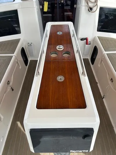 Sirene Yacht Photos Pics Cockpit of 2019 Dufour 390 GL sailboat with wooden table and Raymarine equipment.