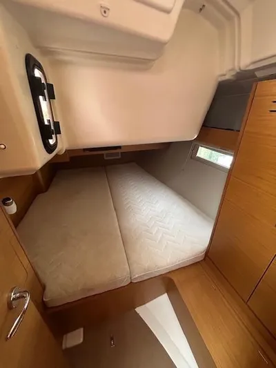 Sirene Yacht Photos Pics Cabin interior of 2019 Dufour 390 GL yacht with twin beds and wooden finish.