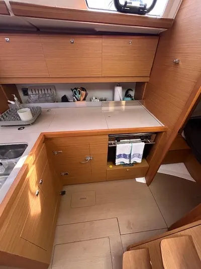 Sirene Yacht Photos Pics Modern kitchen interior of 2019 Dufour 390 GL yacht with wooden cabinetry.