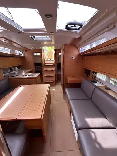 Sirene Yacht Photos Pics Interior of 2019 Dufour 390 GL yacht with modern wood finish and seating area.