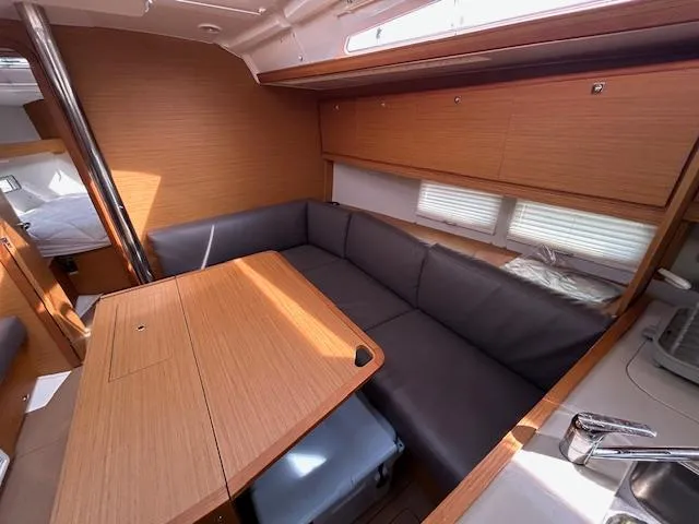 Sirene Yacht Photos Pics 2019 Dufour 390 GL yacht interior with cozy seating and wooden table.