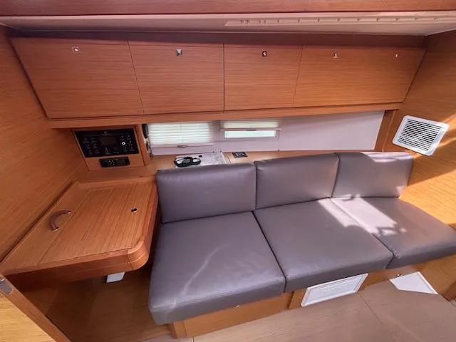 Sirene Yacht Photos Pics Interior of 2019 Dufour 390 GL yacht with wooden cabinets and gray seating.