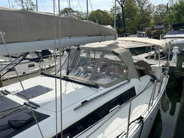 Sirene Yacht Photos Pics 2019 Dufour 390 GL sailboat docked, featuring a beige canopy and sleek design.
